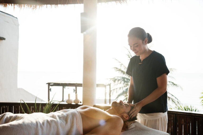 A woman is giving a man a massage
