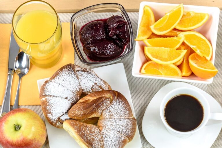 A table topped with lots of food and drinks.