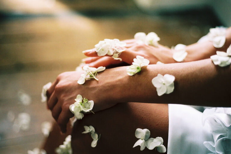 A person with their hands covered by flowers.